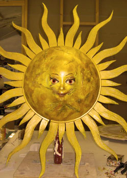 music video gold prop sun head